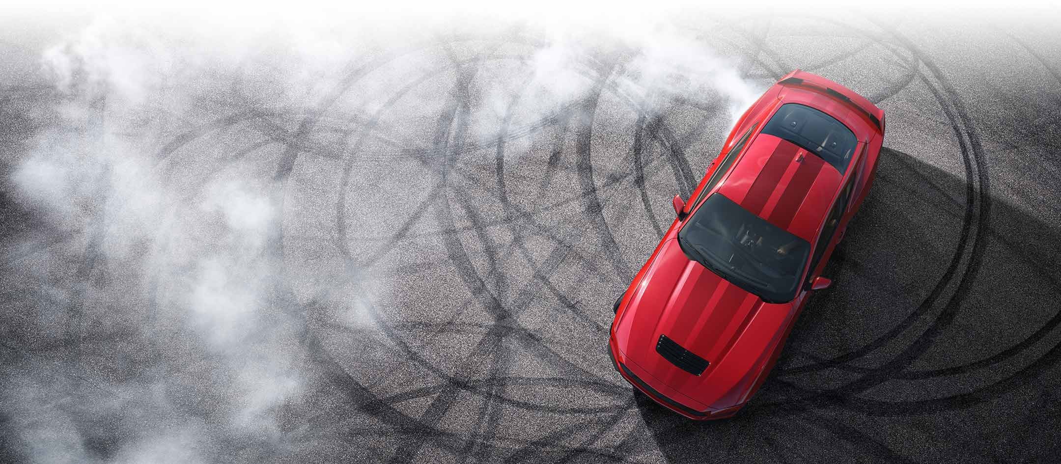Overhead view of a 2024 Ford Mustang® model with tire tracks on pavement | SouthWest Ford in Weatherford TX