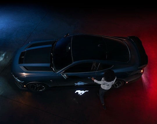 2024 Ford Mustang® Dark Horse™ model with a driver approaching the vehicle | SouthWest Ford in Weatherford TX